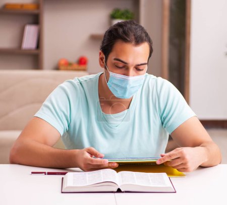 Photo for Young student studying at home during pandemic - Royalty Free Image