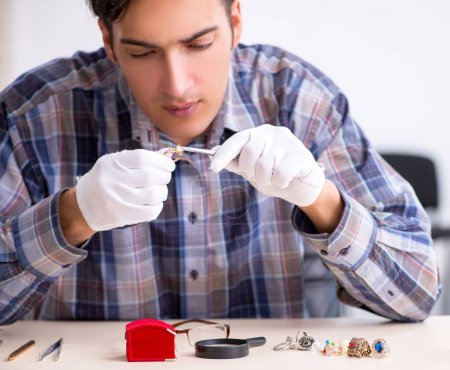 Photo for The young male jeweler at workshop - Royalty Free Image