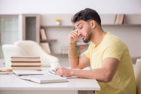 Photo for Young student studying at home during pandemic - Royalty Free Image