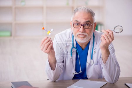 Photo for Old doctor sitting at the hospital - Royalty Free Image