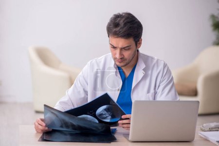 Photo for Young male doctor radiologist working in the clinic - Royalty Free Image
