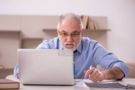 Photo for Old businessman employee working from home during pandemic - Royalty Free Image