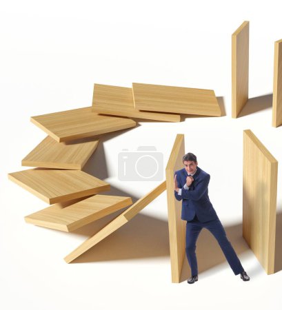 Téléchargez les photos : Homme d'affaires dans le concept d'effet domino - en image libre de droit