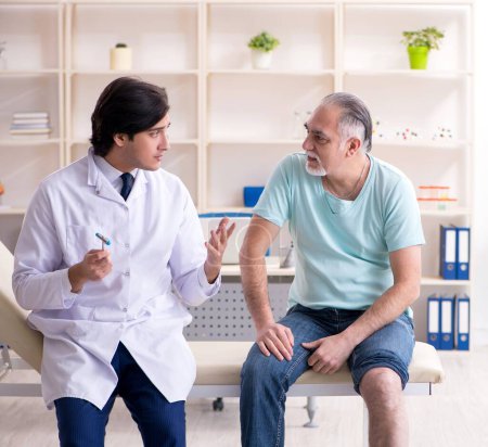 Photo for The old man visiting young male doctor - Royalty Free Image