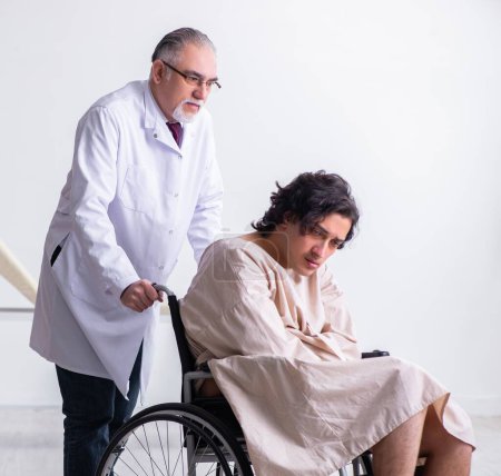 Photo for The old male doctor psychiatrist and patient in wheel-chair - Royalty Free Image