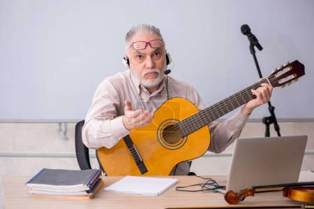 Photo for Old music teacher in the classroom - Royalty Free Image