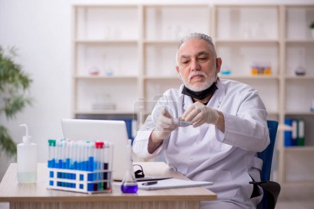 Photo for Old chemist working at the lab - Royalty Free Image