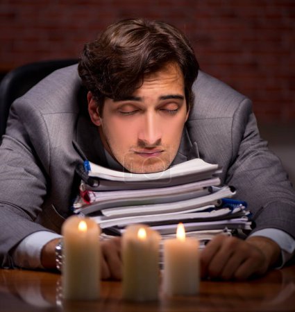 Photo for The businessman working late in office with candle light - Royalty Free Image