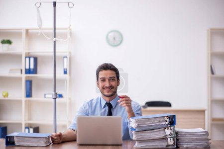Photo for Young businessman employee suffering at workplace - Royalty Free Image