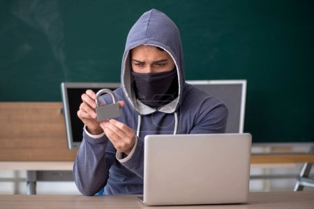 Photo for Young hacker sitting in the classroom - Royalty Free Image