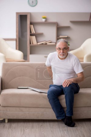 Photo for Old man sitting at home during pandemic - Royalty Free Image