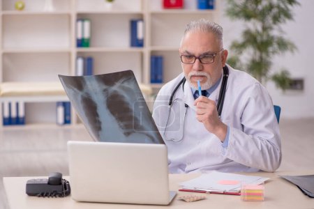 Photo for Old male doctor radiologist working at the hospital - Royalty Free Image