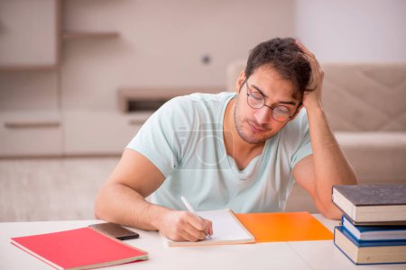 Photo for Young student preparing for exams at home - Royalty Free Image