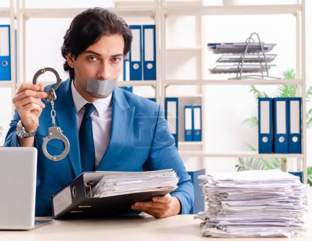 Foto de El joven empleado con cinta adhesiva en la boca - Imagen libre de derechos