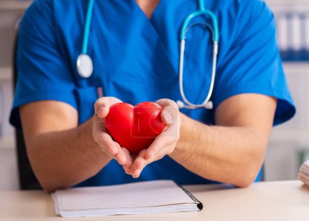 Photo for The male doctor cardiologist holding heart model - Royalty Free Image