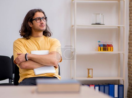 Photo for Young student waiting for teacher in the classroom - Royalty Free Image