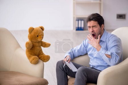 Photo for Young psychologist meeting with toy bear - Royalty Free Image