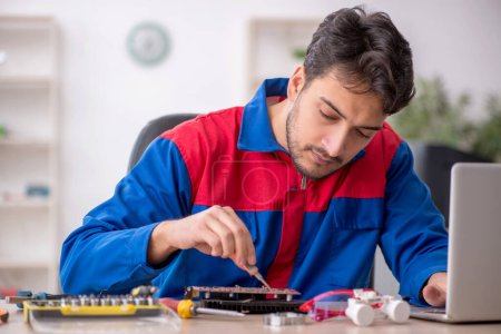 Photo for Young repairman repairing computer at the lab - Royalty Free Image