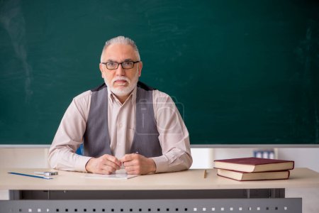 Photo for Old teacher in the classroom - Royalty Free Image