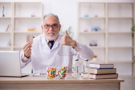 Photo for Old doctor suggesting pills at the hospital - Royalty Free Image