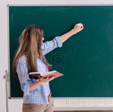 Photo for The female student in front of chalkboard - Royalty Free Image