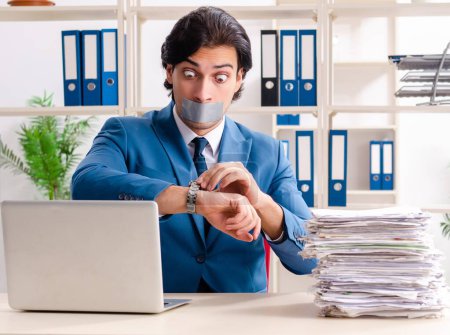Photo for The young male employee with tape on the mouth - Royalty Free Image