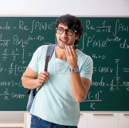 Photo for The young male student mathematician in front of chalkboard - Royalty Free Image