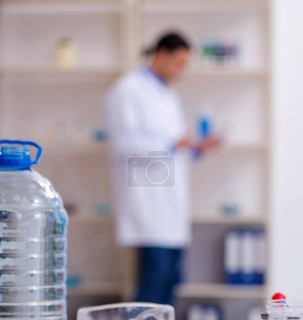 Photo for The young male chemist experimenting in lab - Royalty Free Image