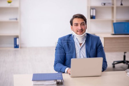 Photo for Young businessman employee after car accident in the office - Royalty Free Image
