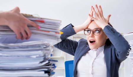 Photo for The tired businesswoman with paperwork workload - Royalty Free Image
