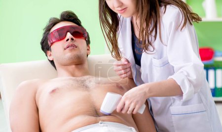 Photo for The young man visiting doctor for epilation - Royalty Free Image