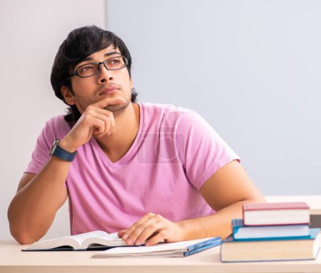 Photo for The young male student sitting in the class - Royalty Free Image
