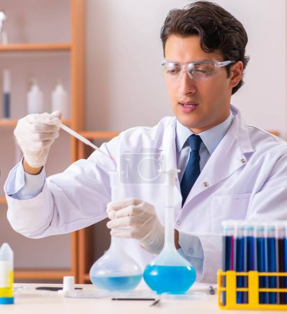 Photo for The young handsome biochemist working in the lab - Royalty Free Image