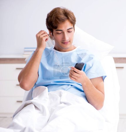 Photo for The young male patient lying on couch in hospital - Royalty Free Image