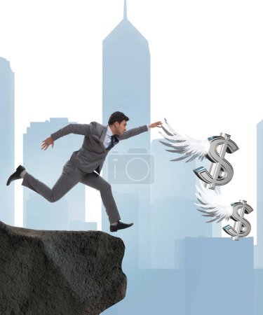 Foto de El hombre de negocios persiguiendo dólares ángel en concepto de negocio - Imagen libre de derechos