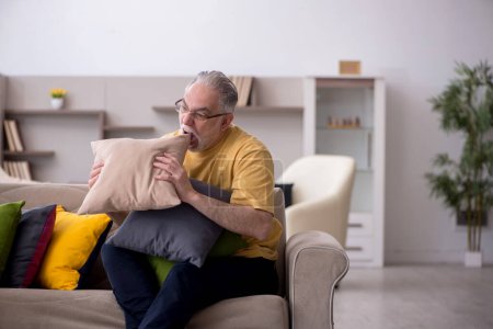 Photo for Aged man with many pillows at home - Royalty Free Image