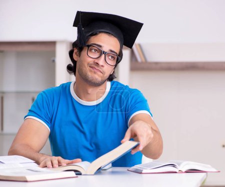 Photo for The young handsome student studying at home - Royalty Free Image