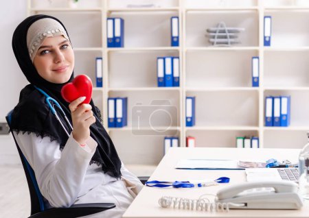 Photo for The young doctor in hijab working in the clinic - Royalty Free Image