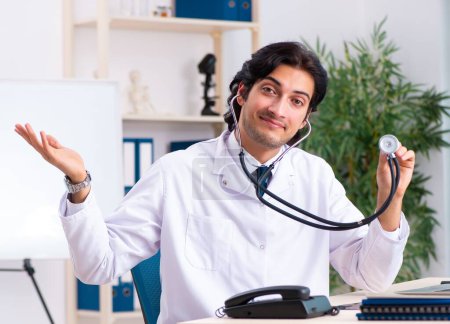 Photo for The young handsome doctor working in clinic - Royalty Free Image