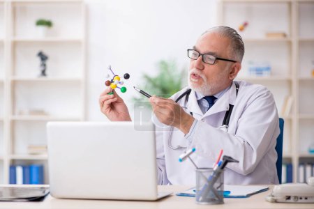Photo for Old doctor holding molecular model - Royalty Free Image
