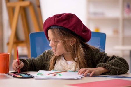 Photo for Young small girl enjoying painting at home - Royalty Free Image