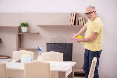 Photo for Old man cleaning the house - Royalty Free Image