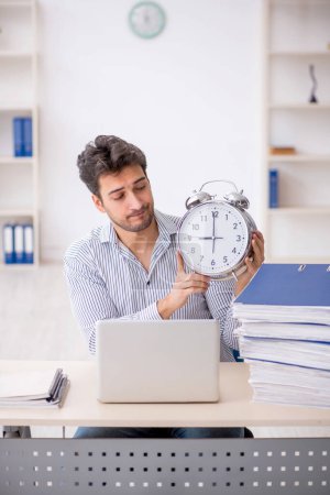 Photo for Young employee in time management concept - Royalty Free Image