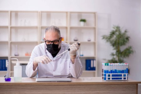 Photo for Old chemist working at the lab - Royalty Free Image