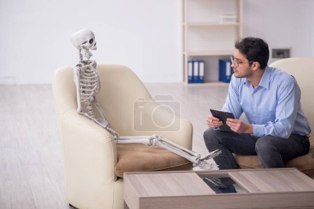 Photo for Young psychologist meeting with skeleton - Royalty Free Image