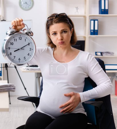 Photo for The old pregnant woman working in the office - Royalty Free Image