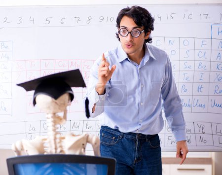 Photo for The young male chemist teacher and student skeleton - Royalty Free Image