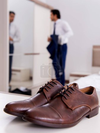 Photo for The young handsome businessman choosing shoes at home - Royalty Free Image
