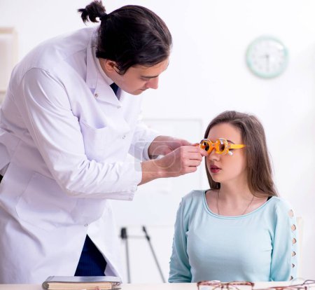 Photo for The young woman visiting male doctor oculist - Royalty Free Image