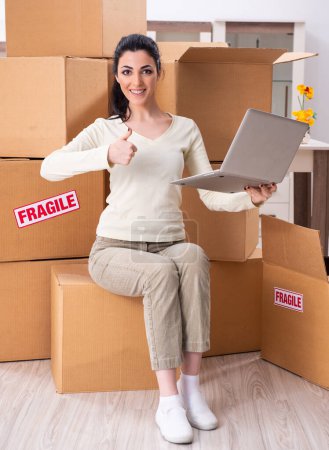 Photo for The young woman moving to new flat - Royalty Free Image